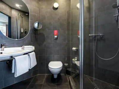 a hotel room with a bed and a ladder at Hotel Ibis Krakow Centrum in Kraków