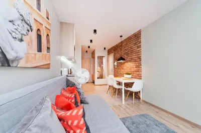 a living room with a couch and a table at Olimp Apartments in Kraków