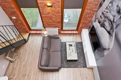 an overhead view of a living room with a couch at Olimp Apartments in Kraków