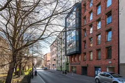 a street in a city with a large brick building at Olimp Apartments in Kraków