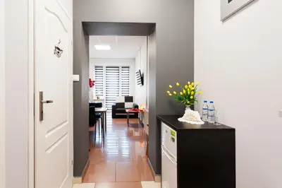 a hallway with a black counter and a living room at Apartament Solny Wieliczka Centrum 5 in Wieliczka