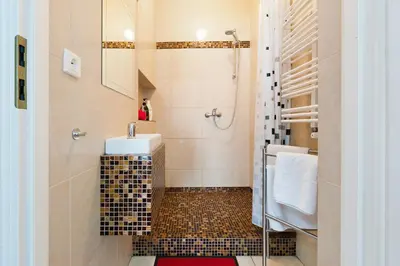 a bathroom with a sink and a shower at Apartament Solny Wieliczka Centrum 5 in Wieliczka