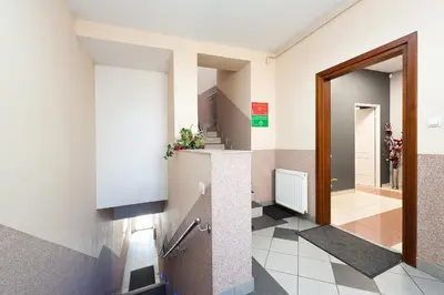 a hallway of a building with a door and a hallway at Apartament Solny Wieliczka Centrum 5 in Wieliczka