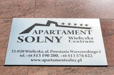 a sign for an apartment county on the ground at Apartament Solny Wieliczka Centrum 5 in Wieliczka