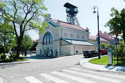 a large building with a windmill on the side of a street at Apartament Solny Wieliczka Centrum 5 in Wieliczka