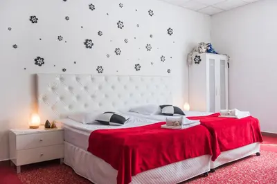 a bedroom with a large white bed with red sheets at Apartament Solny Wieliczka Centrum 5 in Wieliczka