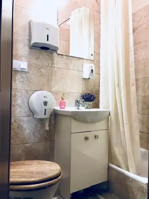 a bathroom with a toilet and a sink at Hostel u Kmity in Kraków