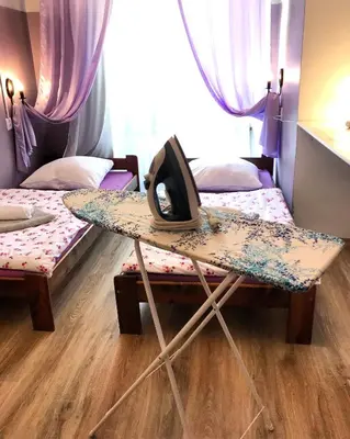 a room with two beds and a table with a hat on it at Hostel u Kmity in Kraków