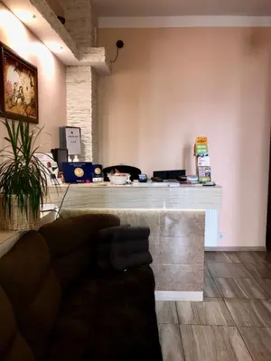 a lobby with a counter with a couch in a room at Hostel u Kmity in Kraków