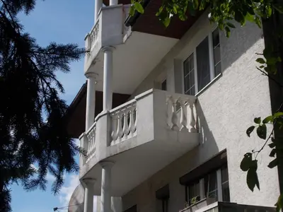 a building with a balcony on the side of it at Apartamenty Nad Wisłą in Skawina