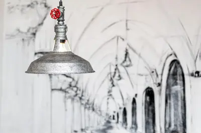 a large metal light hanging from the ceiling of a building at Tomasza Residence in Kraków