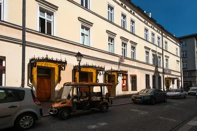 a small golf cart parked in front of a building at Tomasza Residence in Kraków