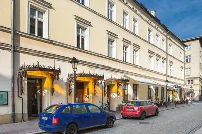 two cars parked in front of a building at Tomasza Residence in Kraków