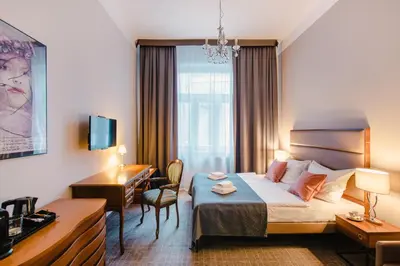 a hotel room with a bed and a chair at Aparthotel Old Town in Kraków