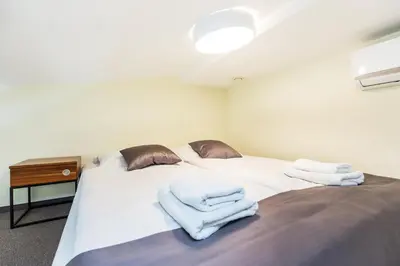 a bedroom with a bed with towels on it at Aparthotel Old Town in Kraków