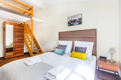 a hotel room with a bed and a desk and a computer at Aparthotel Old Town in Kraków