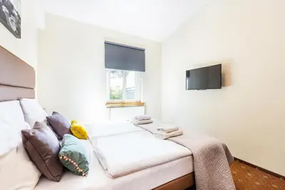 a hotel room with a desk and a bed and a desk and chair at Aparthotel Old Town in Kraków
