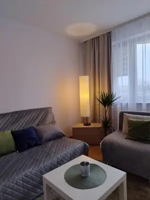 a living room with a couch and a coffee table at GreenApartament in Kraków