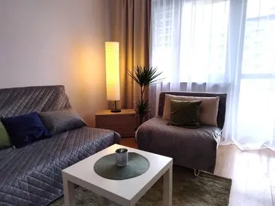 a living room with a couch and a coffee table at GreenApartament in Kraków