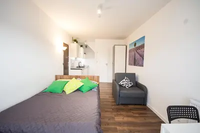 a bedroom with a bed and a chair at Willa Kamilówka in Rabka