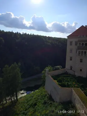a building on a hill next to a river at Nasza Polana Pokoje Noclegi Pieskowa Skała Ojców in Pieskowa Skała
