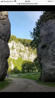 a view of a mountain from between two large rocks at Nasza Polana Pokoje Noclegi Pieskowa Skała Ojców in Pieskowa Skała