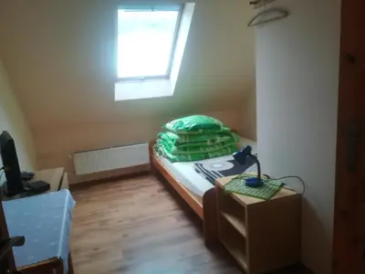 a small bedroom with a bed and a window at Zawoja Pod Grapą in Zawoja