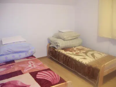 a room with two twin beds and a rug at Zawoja Pod Grapą in Zawoja