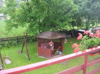 a gazebo with people in it in a yard at Zawoja Pod Grapą in Zawoja