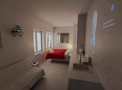 a small bedroom with a bed and a red blanket at Mirror Apartments in Kraków