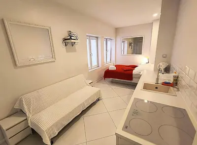 a hospital room with a bed and a sink at Mirror Apartments in Kraków