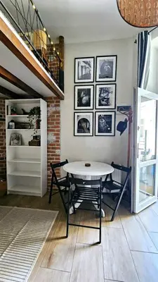 a dining room with a table and a staircase at Studio z ogrodem przy Starej Zajezdni in Kraków
