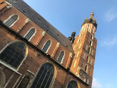 a large brick building with a clock tower at Studio z ogrodem przy Starej Zajezdni in Kraków