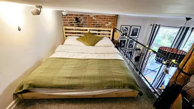 a bedroom with a large bed in a room at Studio z ogrodem przy Starej Zajezdni in Kraków