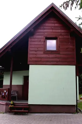 a red and white building with a window at Zawoja Chaty Górskie D3 in Zawoja