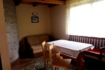 a dining room with a table and chairs and a window at Zawoja Chaty Górskie D3 in Zawoja