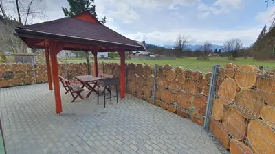 a gazebo with a table and chairs and a fence at Zawoja Chaty Górskie D3 in Zawoja
