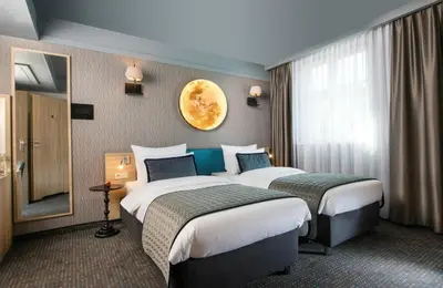 a hotel room with a bathroom with a sink and a shower at Leonardo Boutique Hotel Krakow Old Town in Kraków