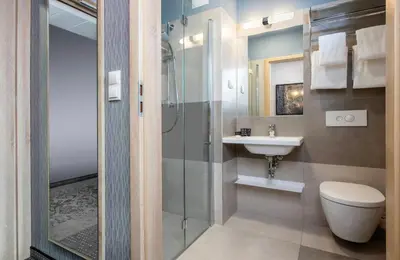 a bathroom with a toilet and a sink and a shower at Leonardo Boutique Hotel Krakow Old Town in Kraków