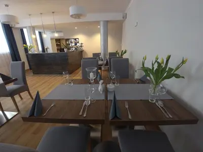 a dining room with two wooden tables and chairs at Brojan in Jaworzno