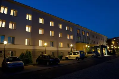a building with cars parked in front of it at Brojan in Jaworzno
