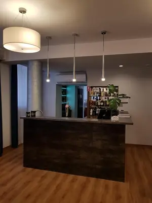 a bar in a room with a person in the mirror at Brojan in Jaworzno
