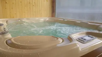 a hot tub with a water fountain in it at Gościniec pod Lubomirem in Węglówka