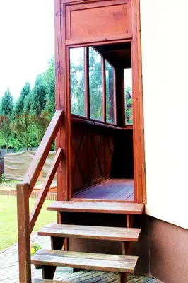 a wooden door with stairs leading to a window at Zawoja Chaty Górskie D5 in Zawoja