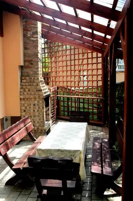 a patio with a table and benches and a fireplace at Zawoja Chaty Górskie D5 in Zawoja