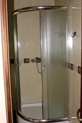 a shower with a glass door in a bathroom at Zawoja Chaty Górskie D5 in Zawoja