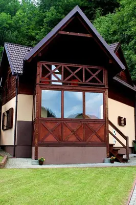 a barn with a large wooden door with a window at Zawoja Chaty Górskie D5 in Zawoja