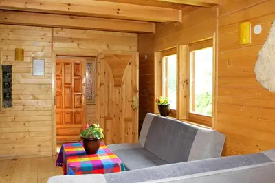 a living room with a couch and a table at Zawoja Chaty Górskie D2 in Zawoja