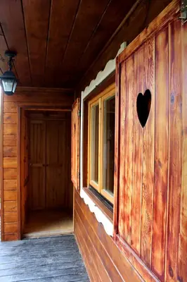 a wooden house with a heart on the wall at Zawoja Chaty Górskie D2 in Zawoja