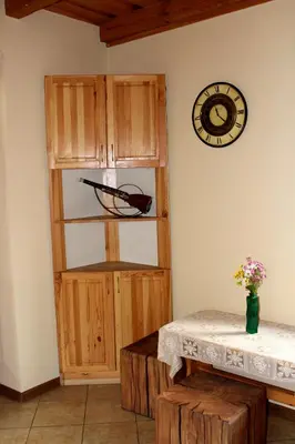 a room with a wooden cabinet and a clock on the wall at Zawoja Chaty Górskie D4 in Zawoja